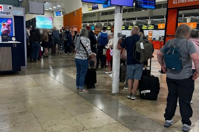 Passengers queuing for information at Liverpool John Lennon Airport late on Thursday after the cancelled Loganair flights