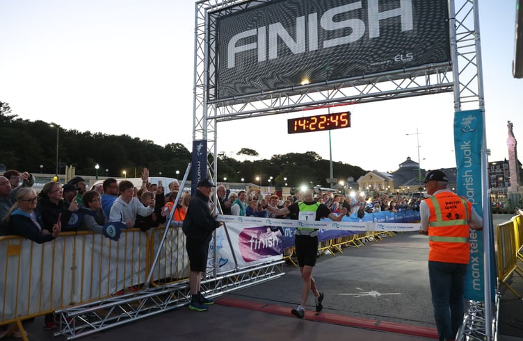 Callum Gawne celebrates as he crosses the finish line to clinch a record-breaking victory in this year's Manx Telecom Parish Walk (Photo: CJS Photography)