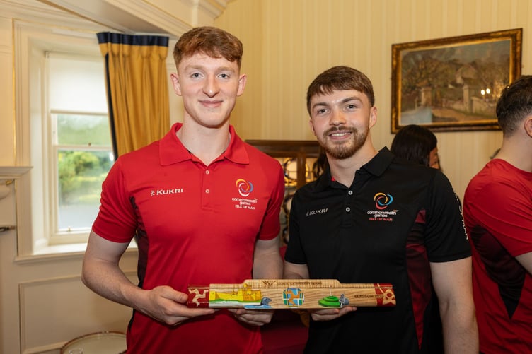 Swimmers Magnus Kelly and Joel Watterson with the baton