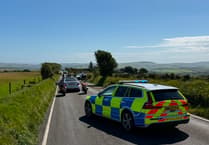 Vehicle rolls in two car crash which shut the Mountain Road