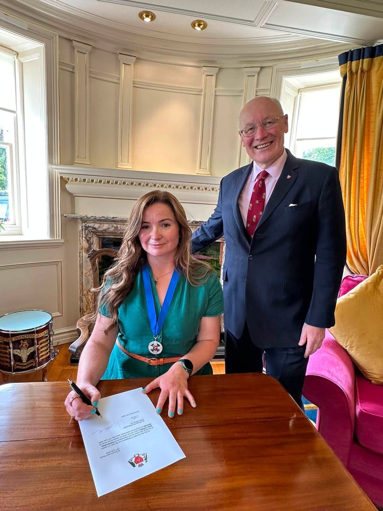 Miss Cannell signing on the dotted line