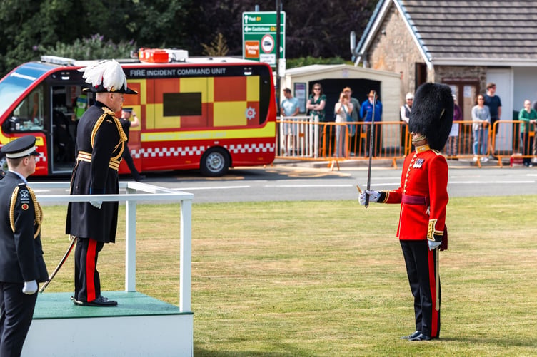 Lieutenant Governor Sir John Lorimer giving a general salute on the saluting dais