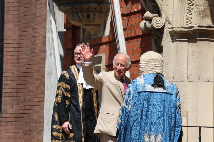 His Majesty the King waving at spectators from afar