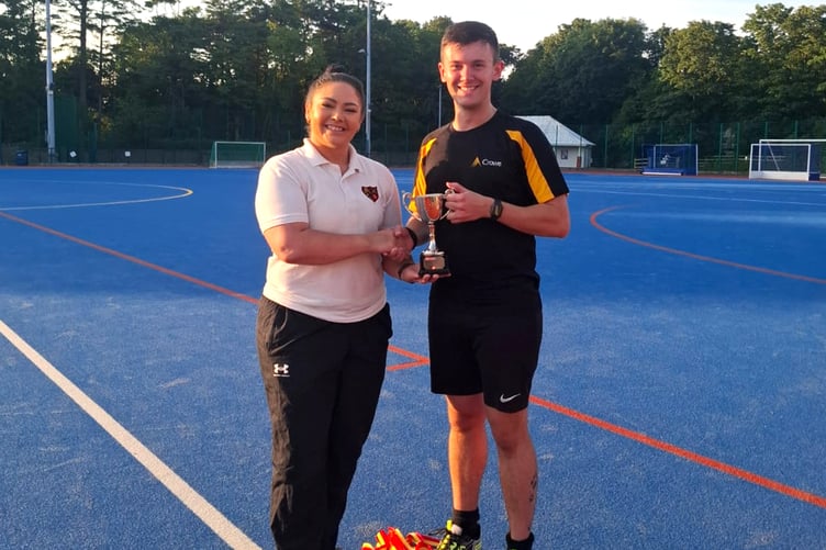 Manx Hockey Association chair Kim Carney presents Crowe IoM captain Ben Kewin with the Social League trophy
