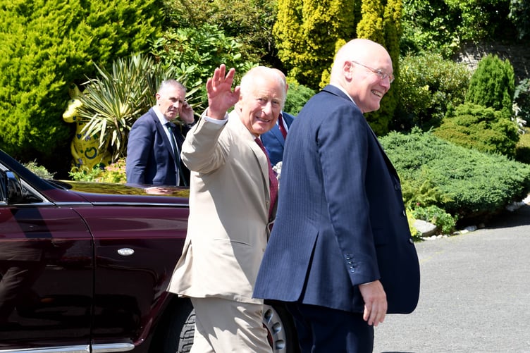 King Charles III waving to the camera