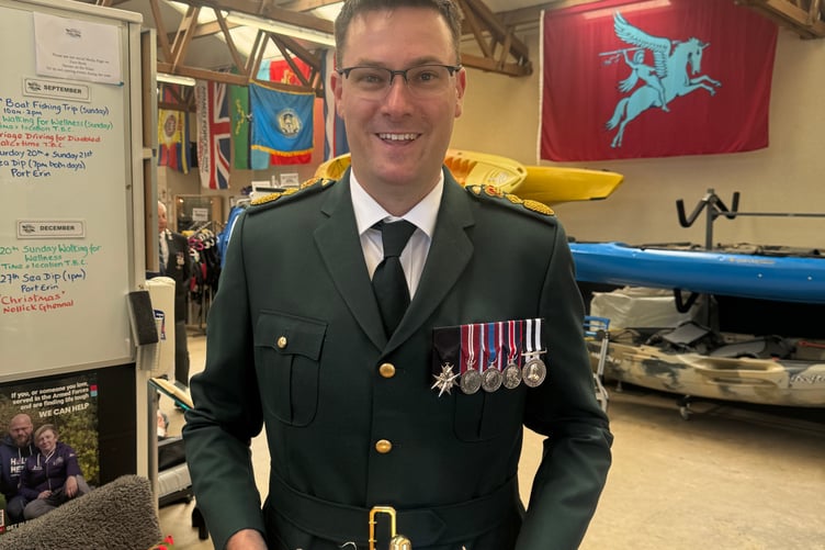 Manx Care’s Divisional Director for Ambulance and Transfer Services, Will Bellamy, with an ambulance bell he was gifting to King Charles III, Lord of Mann