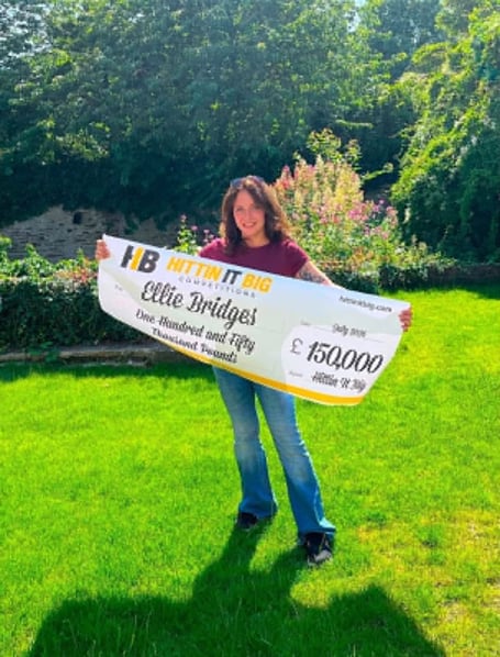 Ellie Bridges holding up the winning banner