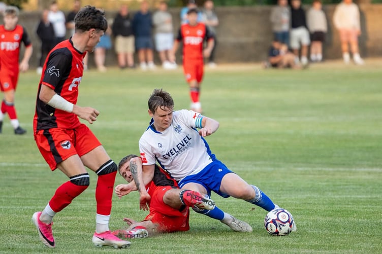 FC Isle of Man's Joe Quayle challenges a Bury opponent during their clash at Ballacloan Stadium on Friday evening (Photo: Hannah McHugh)