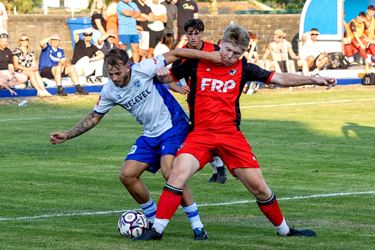 FC Isle of Man's Kyle Watson (right) tussles with a Bury opponent as they battle for the ball (Photo: Hannah McHugh)