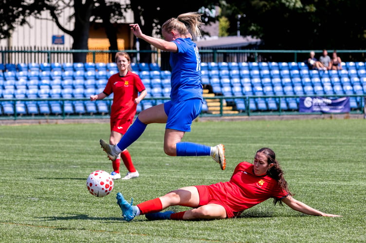 The Isle of Man's Lisa Costain hurdles a challenge from an Ynys Mon opponent during Saturday's second match at the national stadium (Photo: Gary Weightman)