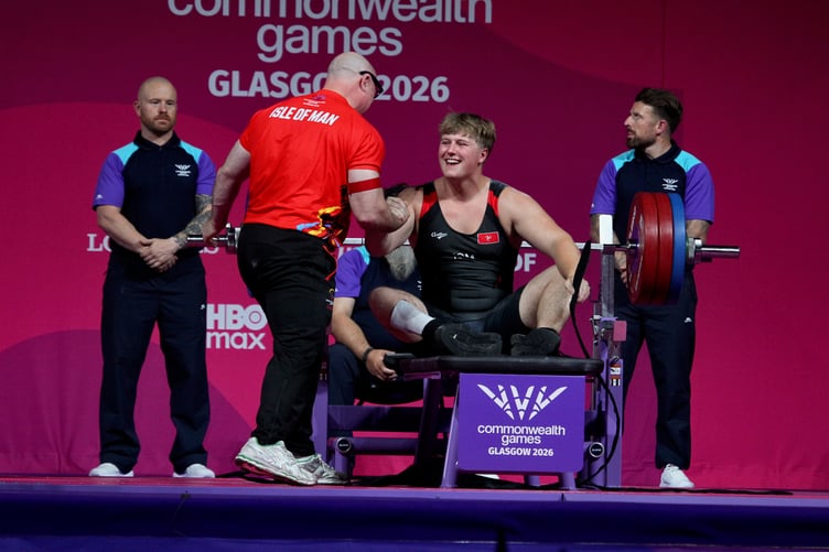 Alfie Bezance celebrates with his coach after his last lift in Friday night's final (Photo: Dave Norton)