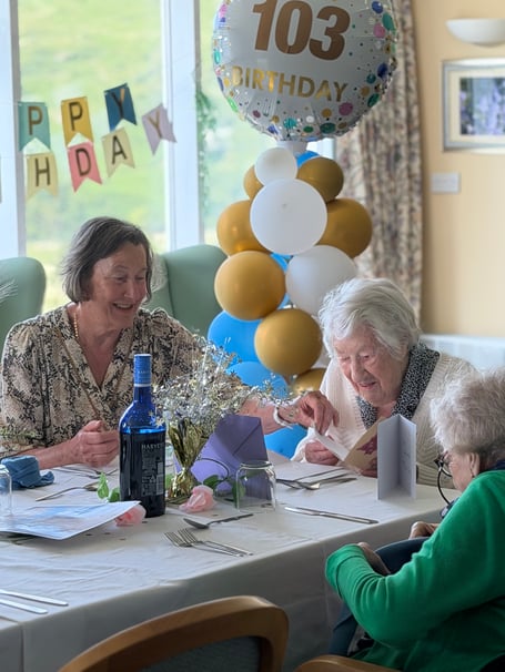 Mildred with her daughter reading cards at her 103rd birthday celebration at Castle View Nursing Home last month 