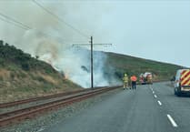 Live updates as wildfire shuts road and stops railway tram in its tracks