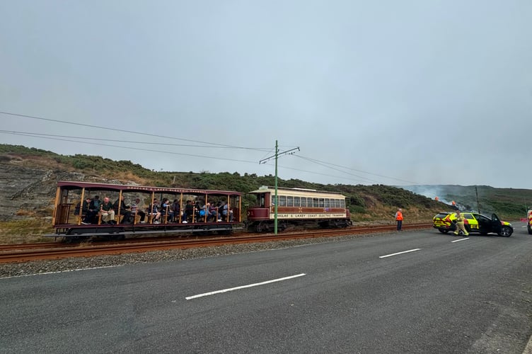 Electric tram passengers waited patiently as fire crews tackled the blaze