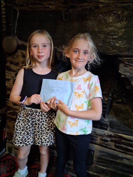 (L-R) Ava Owen, Ella Temple handing over the funds raised from car boot sale