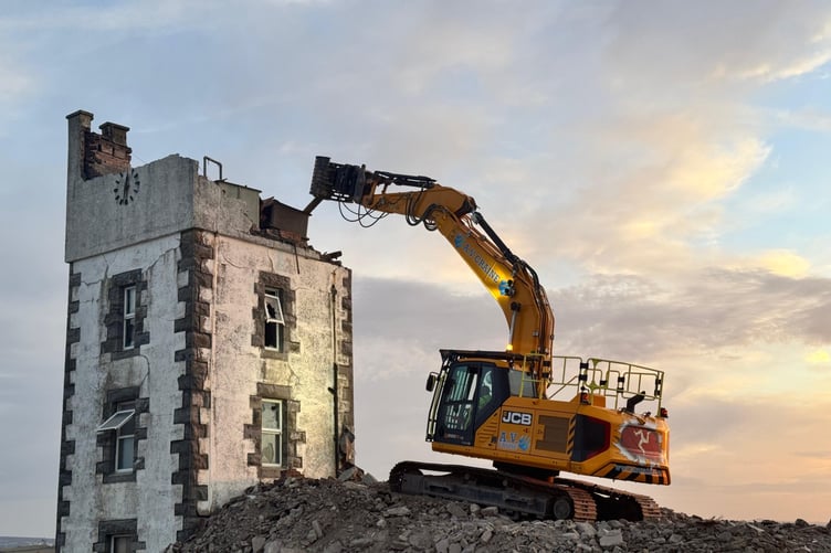 The historic clock tower is reduced to rubble in a controlled demolition