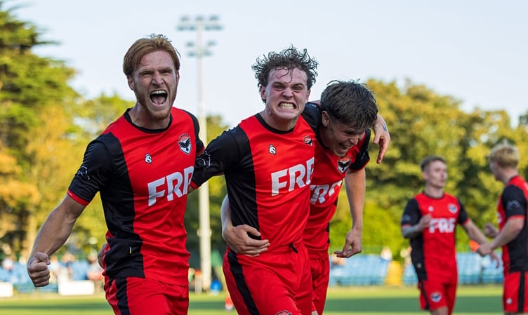 Dean Pinnington (centre) celebrates his winning goal alongside Callum Sherry (left) and Charlie Higgins during FC Isle of Man's dramatic victory on Saturday evening (Photo: Hannah McHugh)