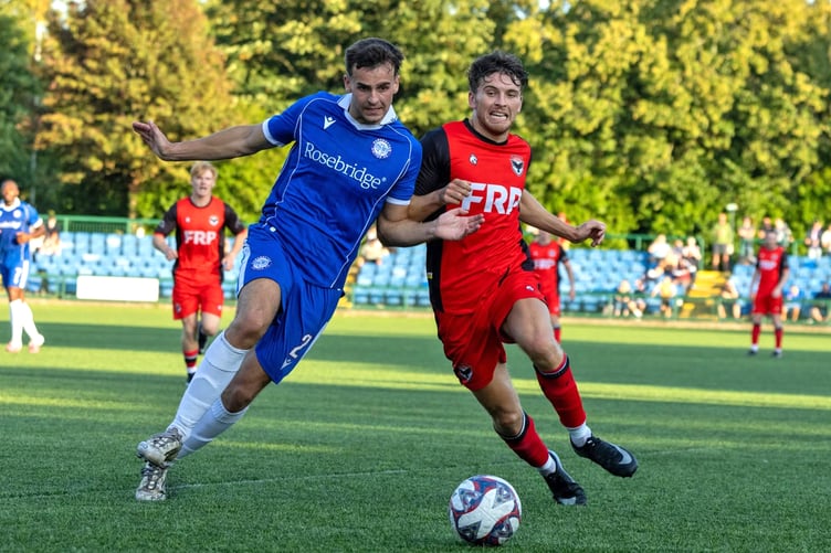 FC Isle of Man's Jacob Crook (right) goes shoulder to shoulder with a Ramsbottom opponent during the weekend's clash at the Bowl (Photo: Hannah McHugh)