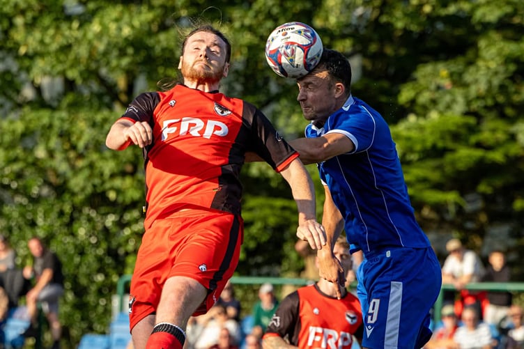Ravens defender Alex Maitland (left) challenges for a header against an opponent during Saturday's Premier Division contest at the national stadium (Photo: Hannah McHugh)