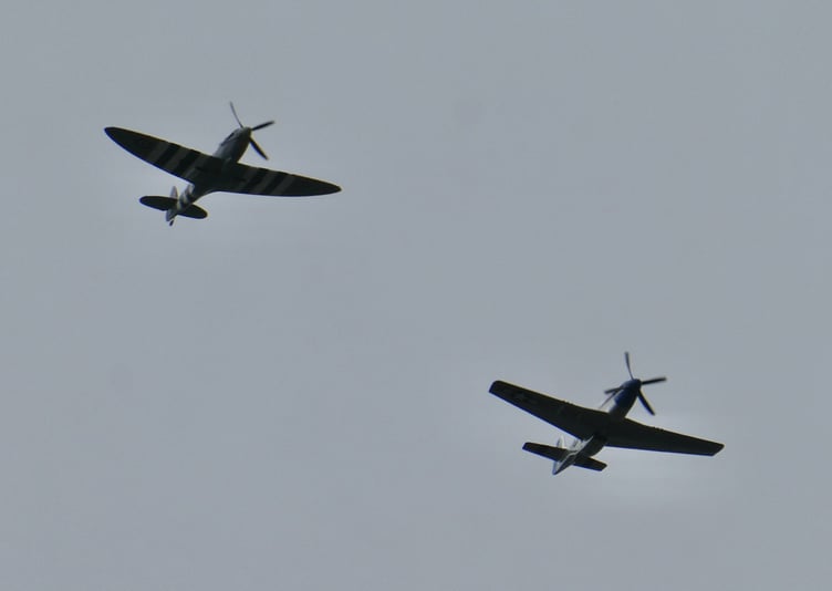 The Spitfire and Mustang flying in formation over Port Erin