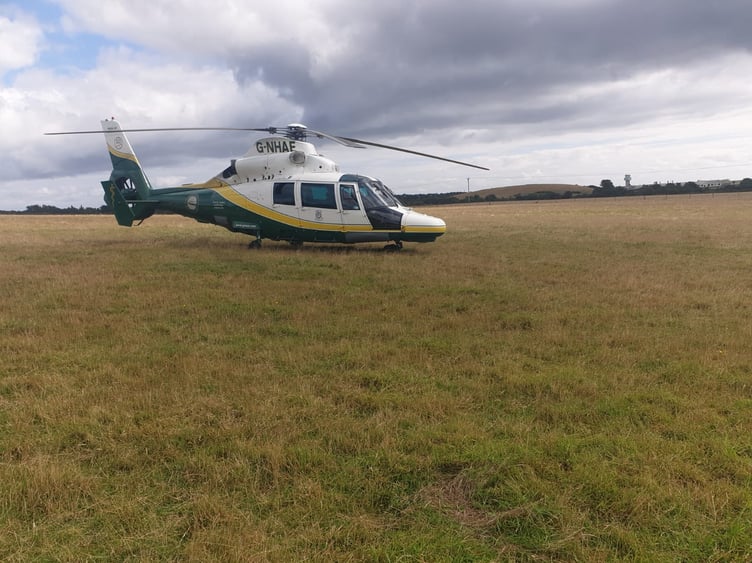 A Great North Air Ambulance Service helicopter lands in Ballasalla after the crash at Church Bends
