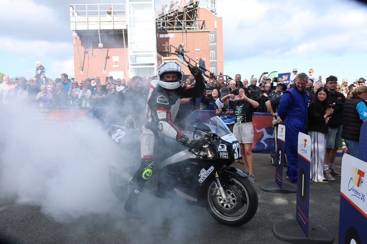 Joe Loughlin does a burnout in the winner's enclosure following victory in the Classic TT's ultra-lightweight race