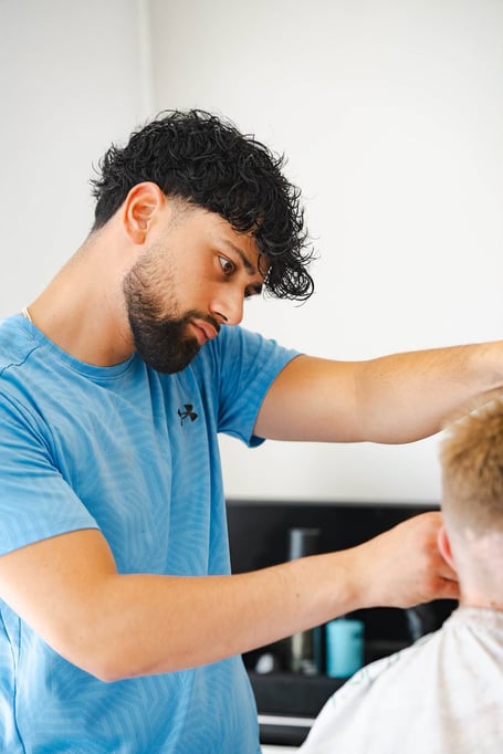 Christos Andrea, who works at Andrea Barbers on Bridge Street in Peel