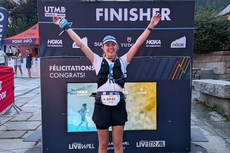 Emily Mylchreest celebrates at the finish after completing the grueling 62km route which featured 3,300 metres of ascent