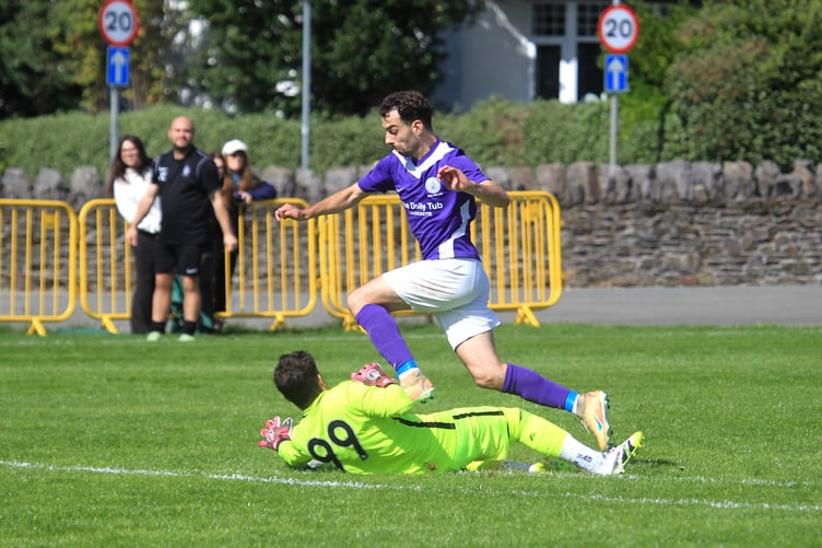 Douglas and District attacker Kieran Lane attempts to round Gymns/DAFC goalkeeper Felipe Santos during Saturday's match. The shot-stopper was penalised for handball which allowed Ash Humphreys to score from the resulting free-kick (Photo: Dave Norton)