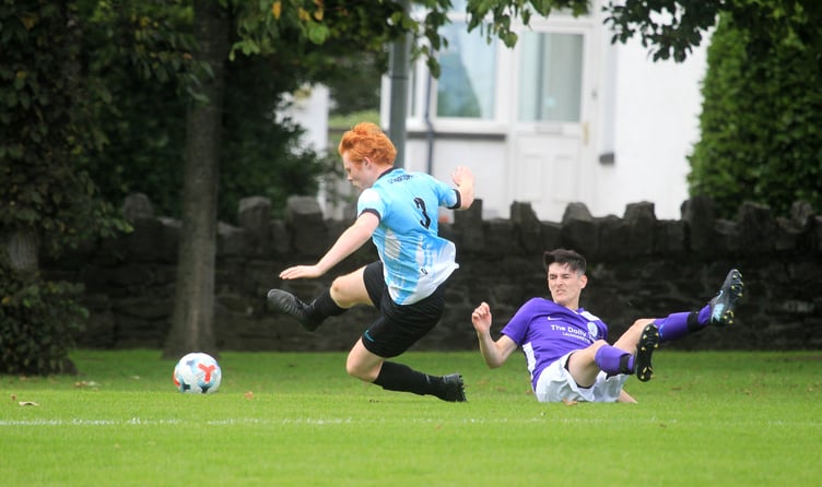 Gymns/DAFC player Corben Kewley is sent tumbling following a challenge from Douglas and District's Rian Gilbert during Saturday's Ardern and Druggan Division Two clash. It was D&D's first match back at Noble's Park on their newly-relaid pitch after several seasons away (Photo: Dave Norton)