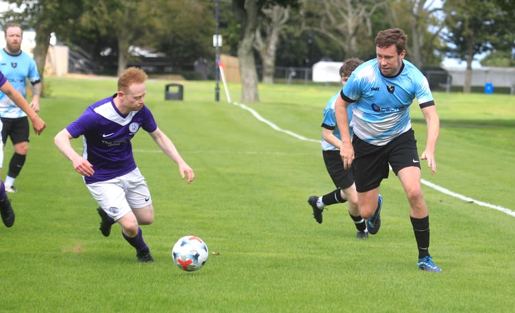 Gymns/DAFC's Will Penhallurick (left) looks for a way past Douglas and District's Lewis Stephens during Saturday's clash at Noble's Park. Penhallurick scored twice in a 6-1 win for his side (Photo: Dave Norton)