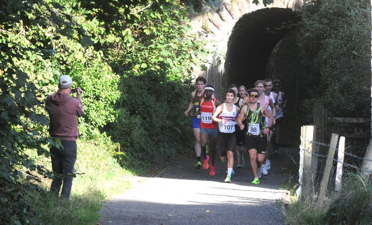 'Say Cheese'. Manxathletics.com's David Griffiths captures the action as the leaders emerge from the railway tunnel at Glenfaba in the early stages of the Peel to Douglas trail race on Sunday. Eventual winner Corbyn Schade is centre (Photo: John Watterson)