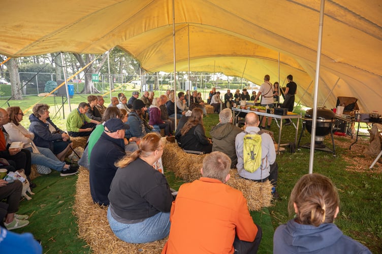 Throughout the day people gathered underneath this teepee to watch food demonstrations take place