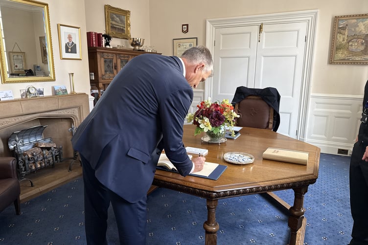 Ian Bates signing himself in for the celebrations at the Town Hall in Douglas