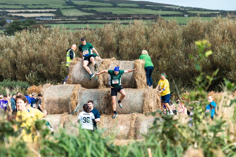 Participants had to climb over a mountain of hay bales