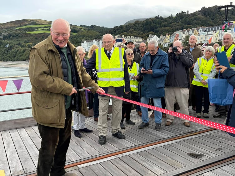 Lieutenant Governor Sir John Lorimer cuts ribbon to formally launch next phase of Queen's Pier restoration project