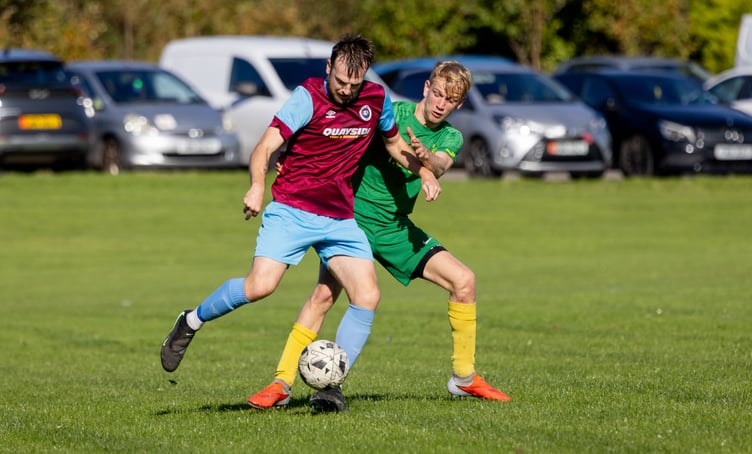 Union Mills striker Luke Booth under pressure from Tyrese Thompson of St Mary's during last week's meeting (Photo: Gary Weightman)