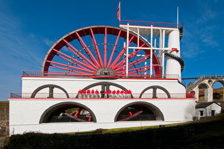 Buchanan and Pitts team infront of the Laxey Wheel after they painted it