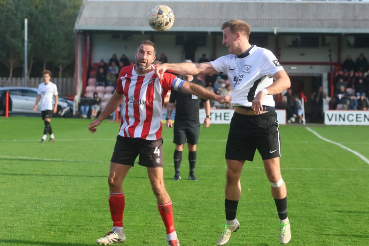 Peel's Matthew Woods (left) and Corinthians' Ryan Burns challenge for a header at Douglas Road (Photo: Paul Hatton)