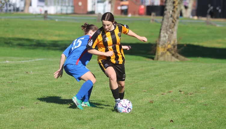 Rushen United's Sadie Corrie attempts to break free from Douglas and District's Manuela Swiatek during Sunday's Women's League clash (Photo: Paul Hatton)