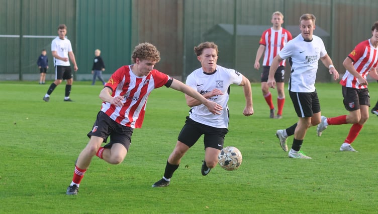 Peel's Oscar Bignall and Corinthians' Morgan Naylor battle for the ball during Saturday's showdown at Douglas Road (Photo: Paul Hatton)