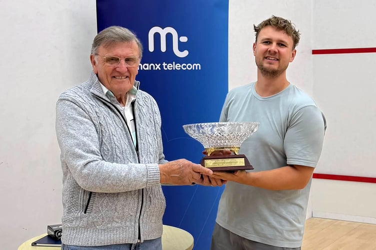 Thomas Whiteway receives the A grade trophy from Dave Karran's brother Bill