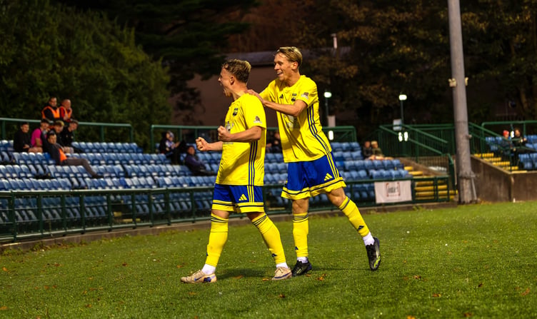 Atherton LR's George Chadwick (left) celebrates his opening goal against FC Isle of Man at the Bowl on Saturday evening