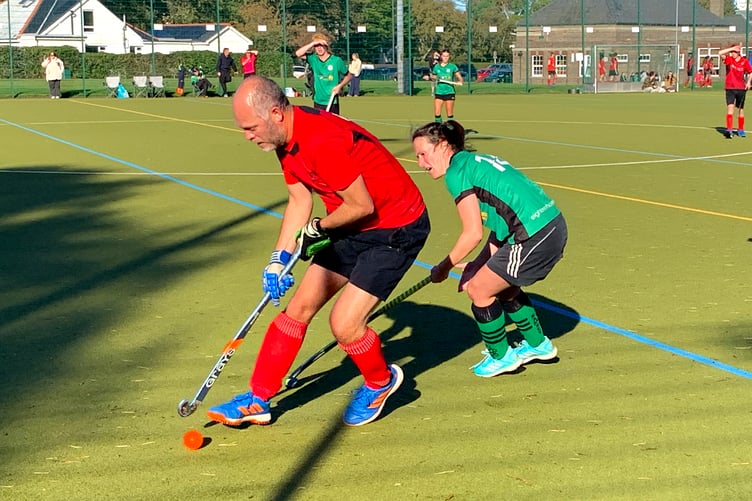 Ramsey 1s' Jo Quine closely marking Castletown Cammags' Mark Webster-Smith during the two sides' Mixed Division One clash at the weekend (Photo: Rachel Andrew)