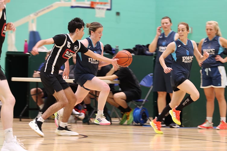 Mairi Harrison pushes the ball down the court for Hoops as Dylan Evans reaches in on defence for Cannons Elite during last week's pre-season tournament at the NSC (Photo: Martin Dunne)