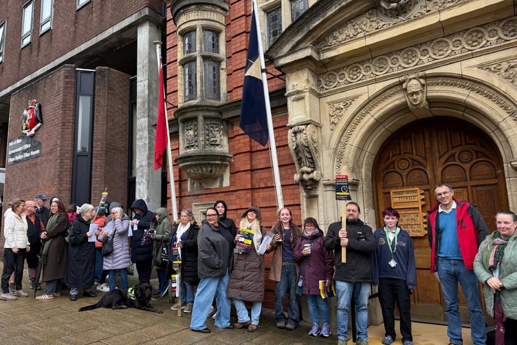 Protestors standing outside the Tynwald building
