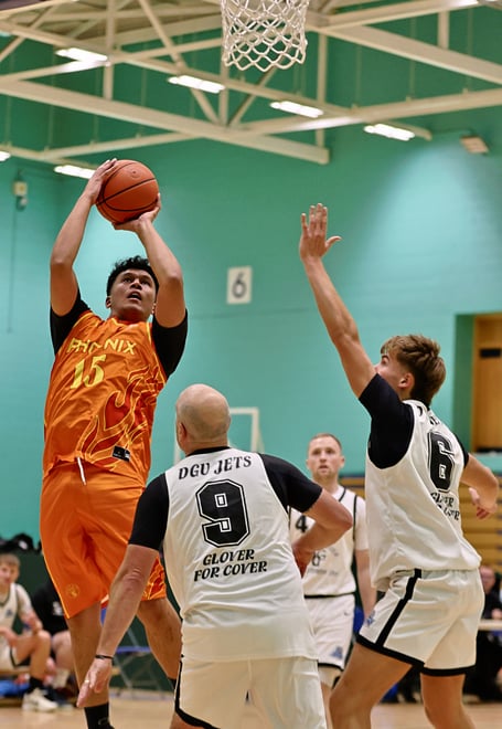 Jowi Szetu shoots the jumper for Southern Phoenix over the defence of DGU Jets' Paul Kilic (No.9) and Logan Glover. A strong performance from Phoenix almost grounded title holders Jets in the opening game of the 2026/27 basketball season (Photo: Martin Dunne)
