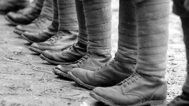 Similar to the memorial at Lezayre, we see a soldier adorning the memorial. We can tell he is a WW1 soldier, from what he is wearing. There is the recognisable Brodie helmet, but also Puttees - long strips of khaki wool that were wrapped tightly around the lower leg, from the ankle to the knee, providing extra support and protection for the soldiers' legs, as well as helping to prevent trench foot - an affliction common among troops deployed in muddy trenches.
Around two million men found themselves in the khaki uniform of the British Army by 1918. The puttee, worn as a binding around the shins, was one of its most distinctive features.
On the west face of the memorial there is a laurel wreath above the main inscription, and a gold cross near the top of the column. On the east face there is a cross in stonework near the top of the column, corresponding with the gold cross on the west face. Originally, four flowers in bronze were provided on each face - alas - two were removed due to damage on the east face and one was broken off the north face.
The architect was Ewart Crellin of Douglas and the sculptor was Harry Hemms & Sons of Exeter and T. Quayle of Douglas.
'They shall grow not old, as we that are left grow old; Age shall not weary them, nor the years condemn. At the going down of the sun and in the morning We will remember them.' - Laurence Binyon